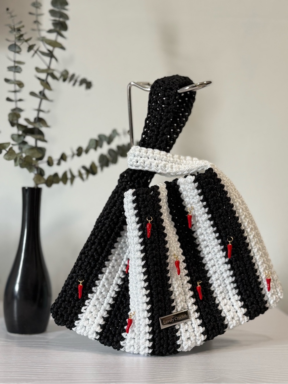 Black and White Striped Crochet Handbag with Red Charm Accents